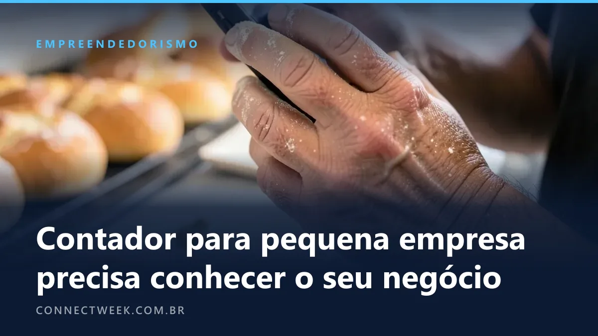 Mãos enfarinhadas de padeiro segurando o telefone no balcão, bandejas de pão desfocadas ao fundo