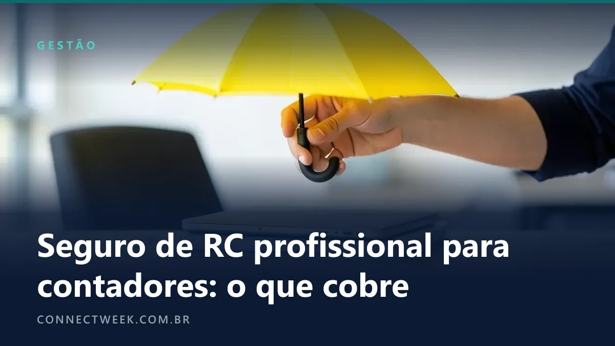 Mão segurando um guarda-chuva amarelo aberto sobre um notebook numa mesa de escritório